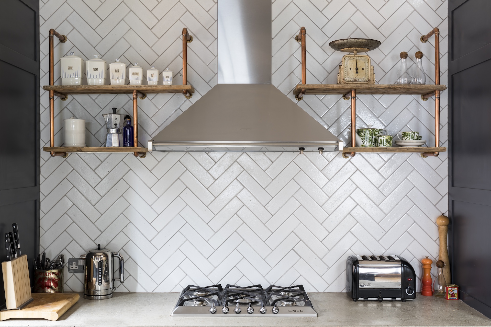 Open timber shelving on exposed brick in a London loft conversion