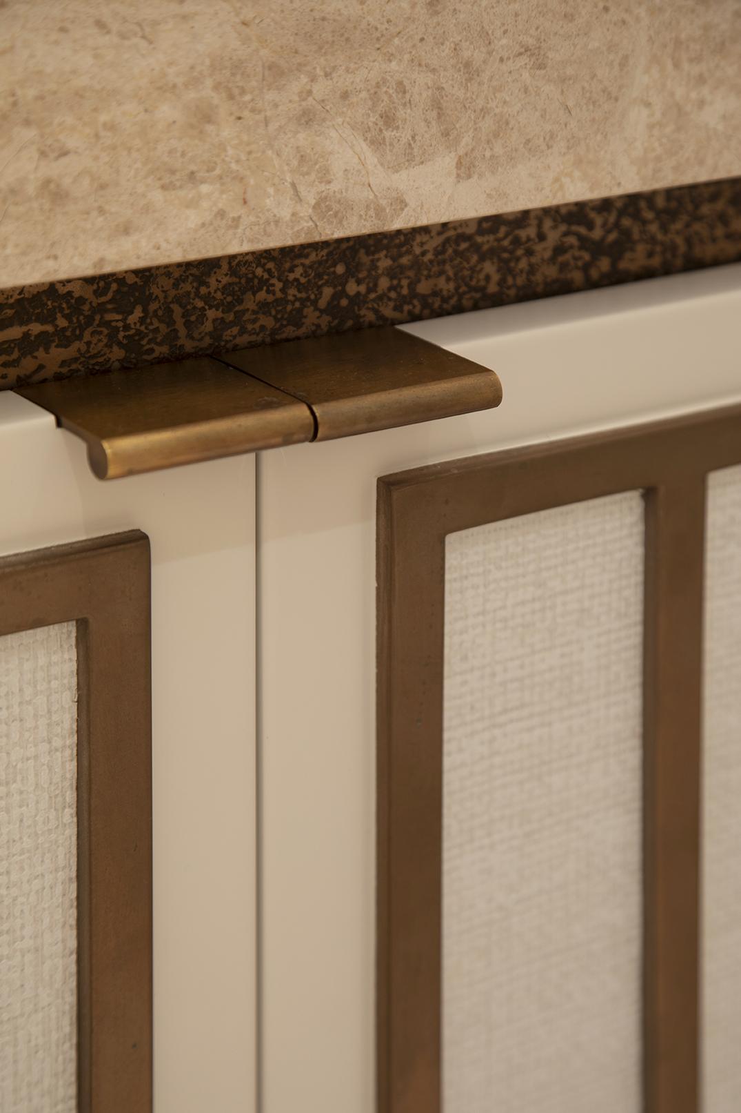 Close-up of bespoke framed panel detail with brass trim, made to measure joinery